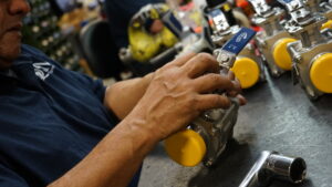 Stainless steel ball valves with handles arranged in production batch for industrial and sanitary applications