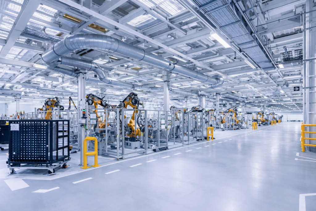 Industrial manufacturing facility with automated robotic systems and stainless steel infrastructure for fluid handling and process control